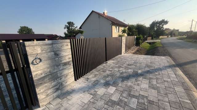 Boczne przęsła aluminiowego ogrodzenia palisadowego wzdłuż podjazdu